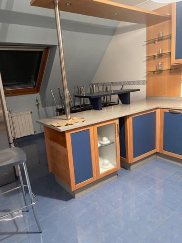 A kitchen or kitchenette at Apartamentos Villa Nustre