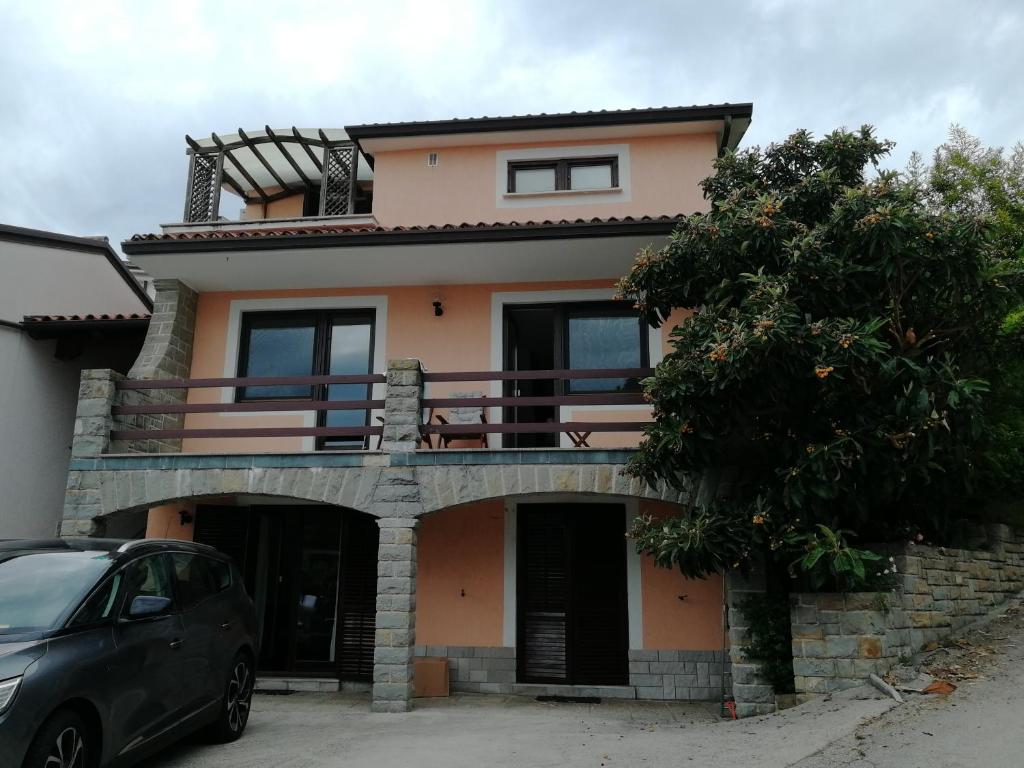 a house with a car parked in front of it at Apartmaji Z Fizine in Portorož