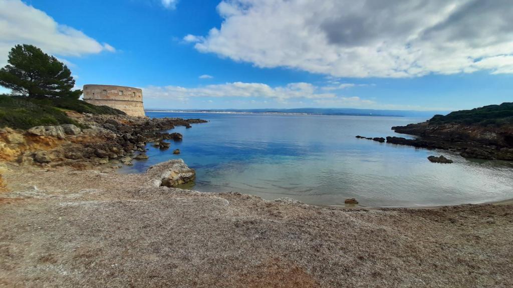 a view of a body of water with a castle at Holiday Home La Quiete in Alghero