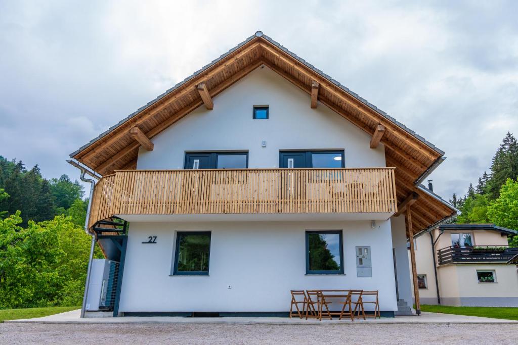 a house with a wooden roof at Na-Ture Apartments in Zgornje Gorje