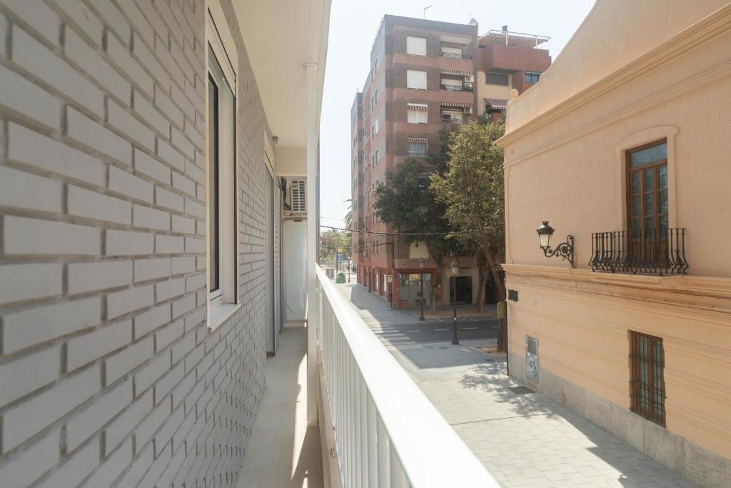 an empty alley in a city with buildings at Reinapart Valencia Beach in Valencia