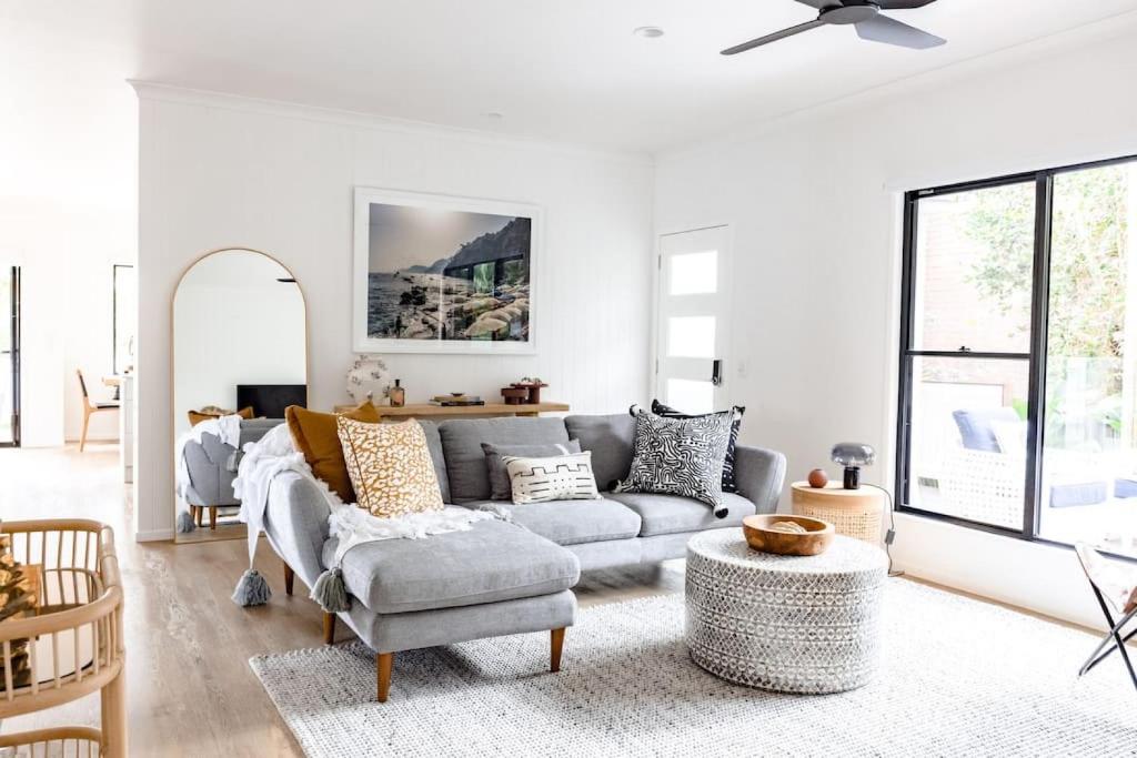 a living room with a couch and a table at BERRIMA LUXE - Noosa Hill Home - Heated Pool in Noosa Heads