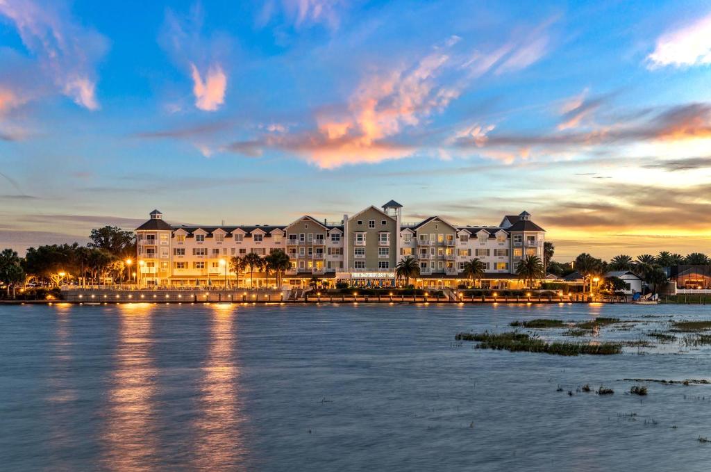 a group of buildings on the water at sunset at The Waterfront Inn in The Villages