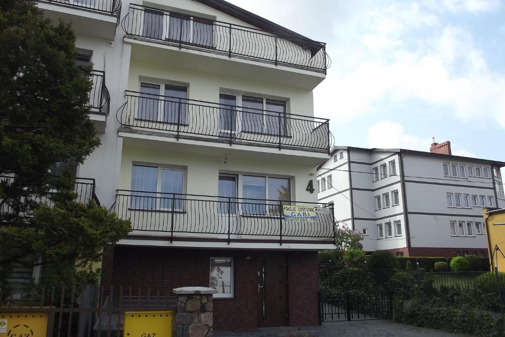 an apartment building with balconies on the side of it at Gabi in Jastrzębia Góra