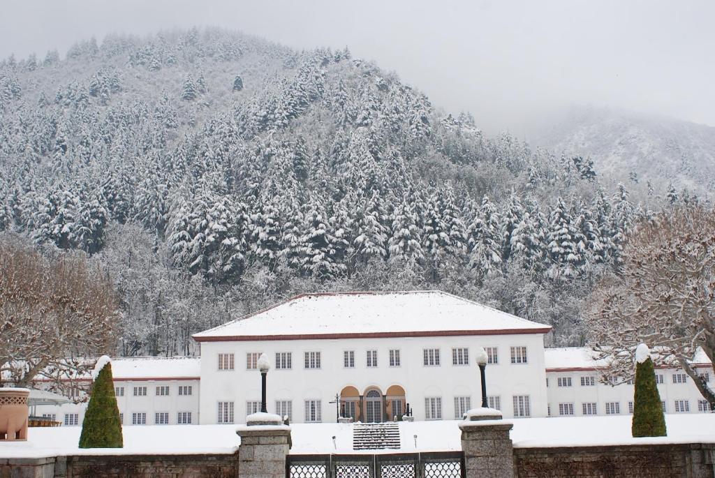 a building in front of a snow covered mountain at The LaLit Grand Palace Srinagar in Srinagar