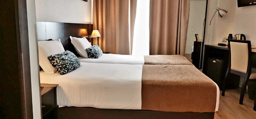 A bed or beds in a room at Lisbon City Hotel by City Hotels