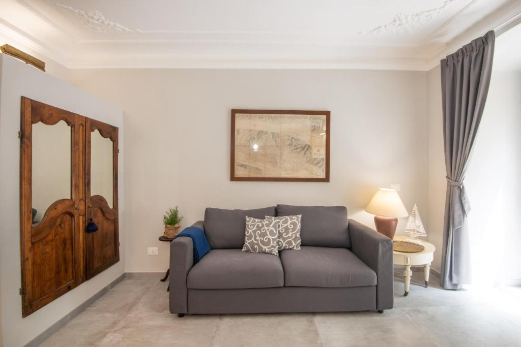 a living room with a couch and a table at Il Genovino Caffa in Genova