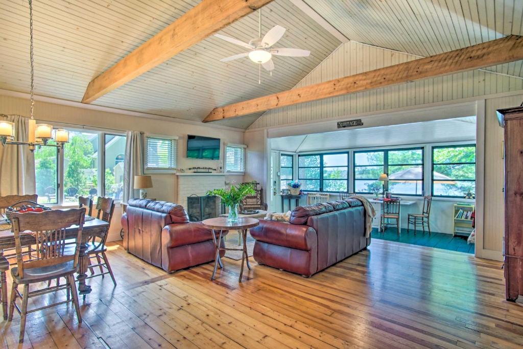 a living room with a couch and a table at Peaceful Long Pond Cottage with Dock and Views in Rochester