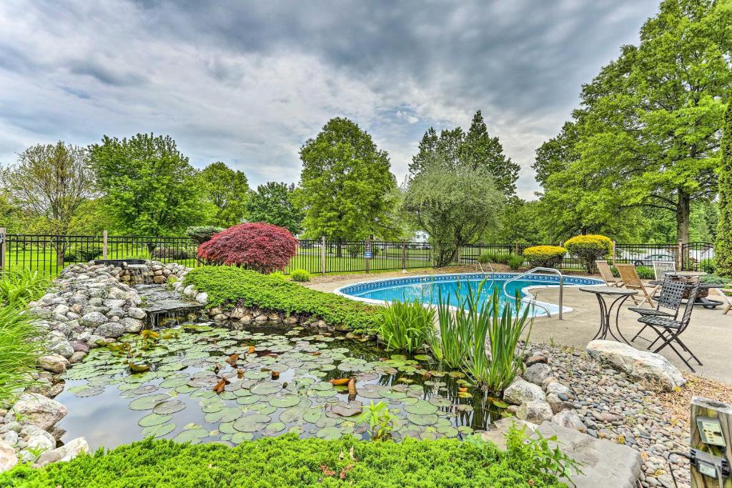 a backyard with a pool with a koi pond at Luxe Montgomery Home with Hot Tub Near Angry Orchard in Montgomery