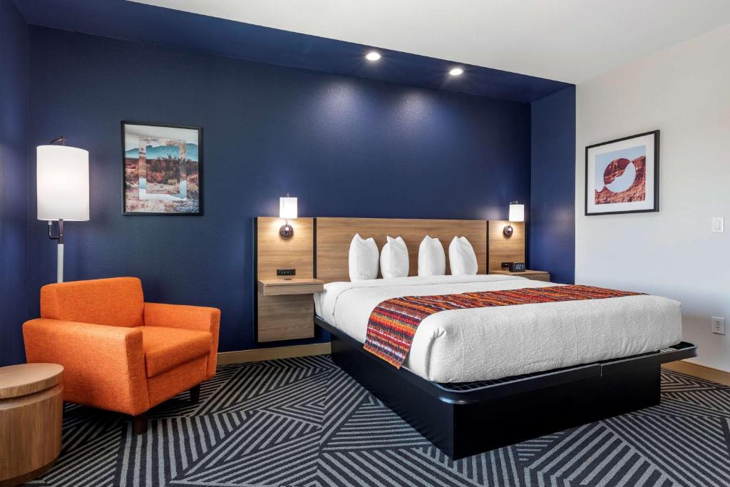 a hotel room with a bed and an orange chair at Best Western Plus Amarillo East Hotel in Amarillo