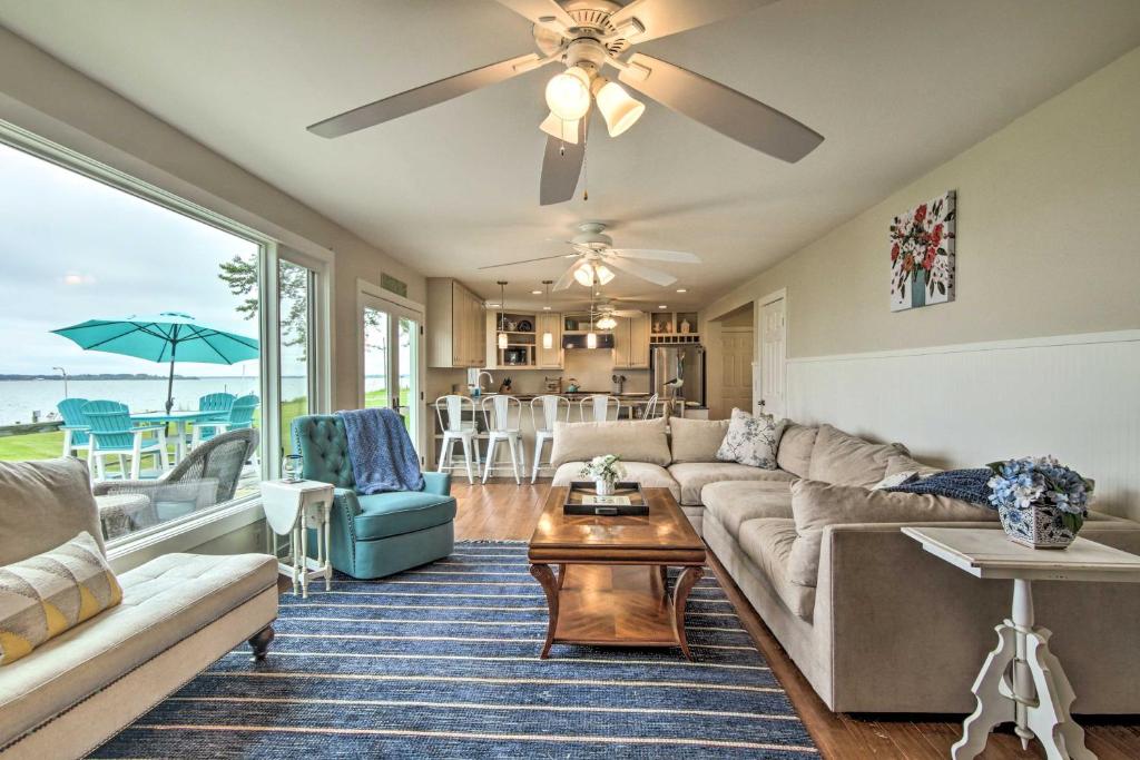 a living room with a couch and a table at Cambridge Beach Home on Choptank River with Pier! in Cambridge