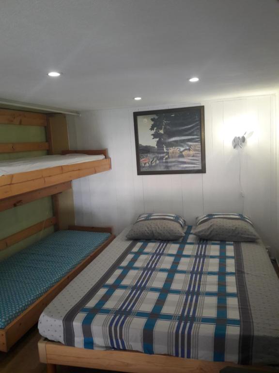 a bedroom with two beds and a bunk bed at EN VENDEE à saint hilaire de riez DUPLEX 4/6pers in Saint-Hilaire-de-Riez