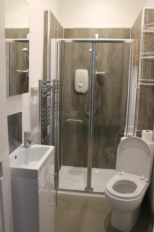 a bathroom with a shower and a toilet and a sink at Newington House in Edinburgh