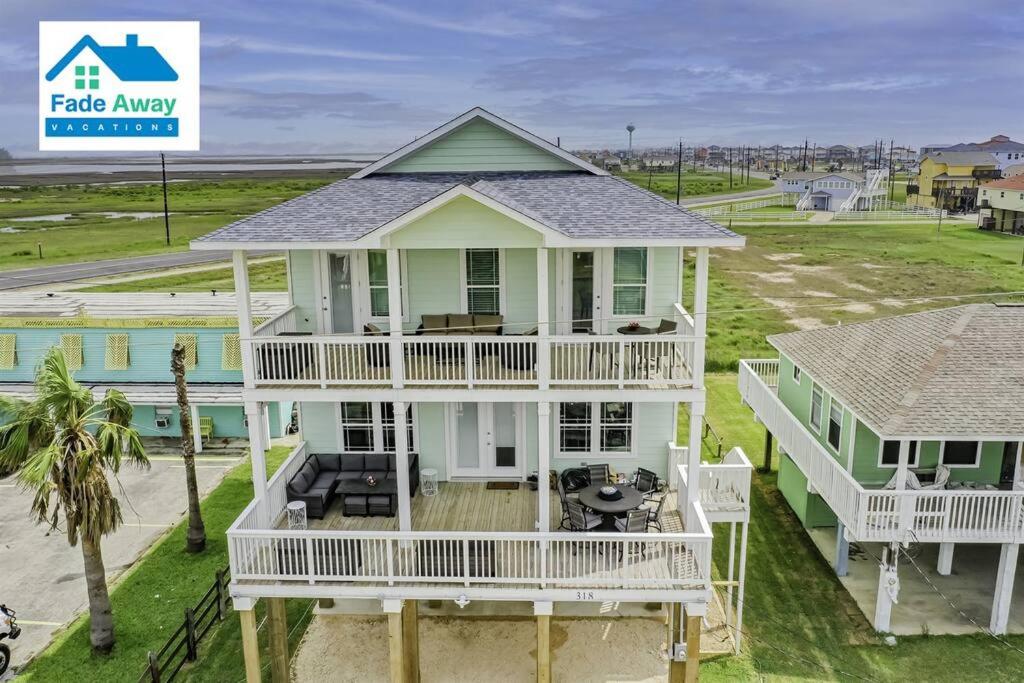 an aerial view of a white house with a porch at Kalm by the Beach - Ocean View - Sleeps 14 in Freeport