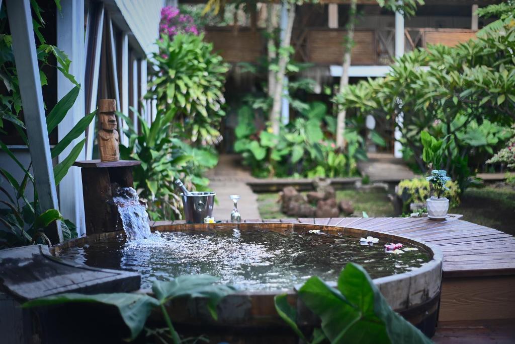 a fountain in the middle of a garden at Hare Nua Hotel Boutique in Hanga Roa