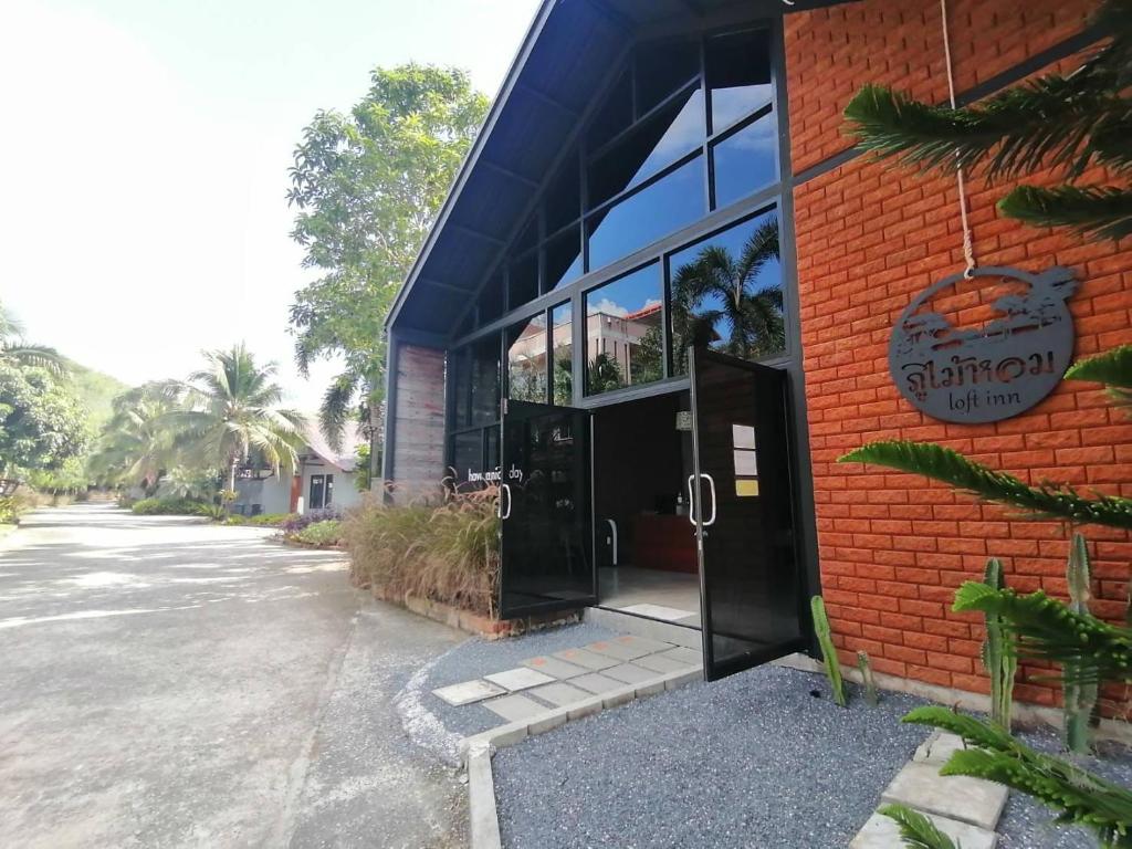 a building with an open door on a street at Phumaihom Resort in Hat Yai