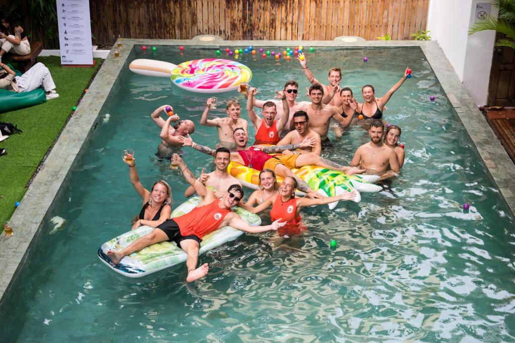 a group of people posing for a picture in a swimming pool at Mad Monkey Hostel Phnom Penh in Phnom Penh