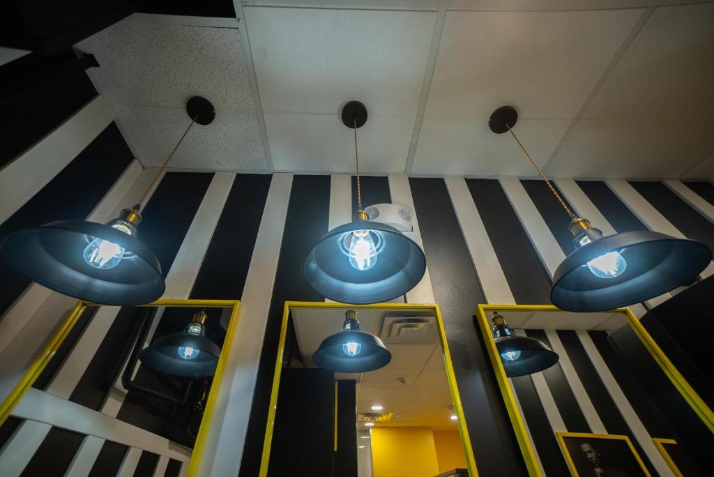 a group of blue lights hanging from the ceiling at Panda Pod Hotel in Richmond