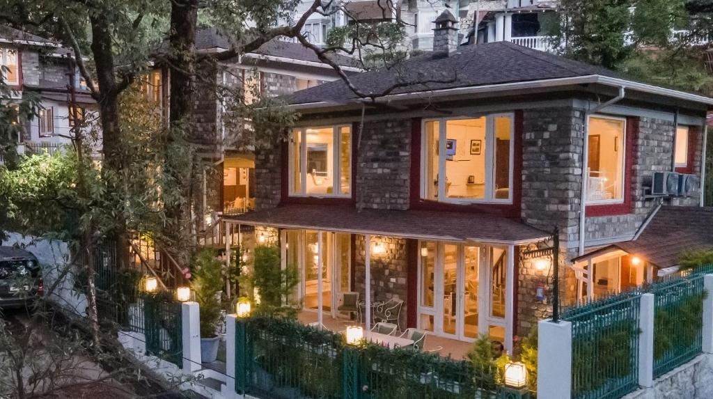 a house with lights on the front of it at Sakley's Cottages in Nainital