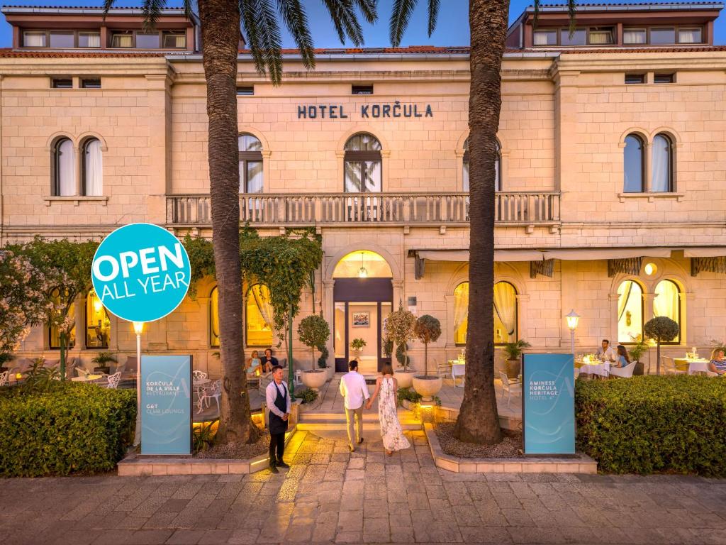 a group of people standing in front of a building at Aminess Younique Korcula Heritage Hotel in Korčula