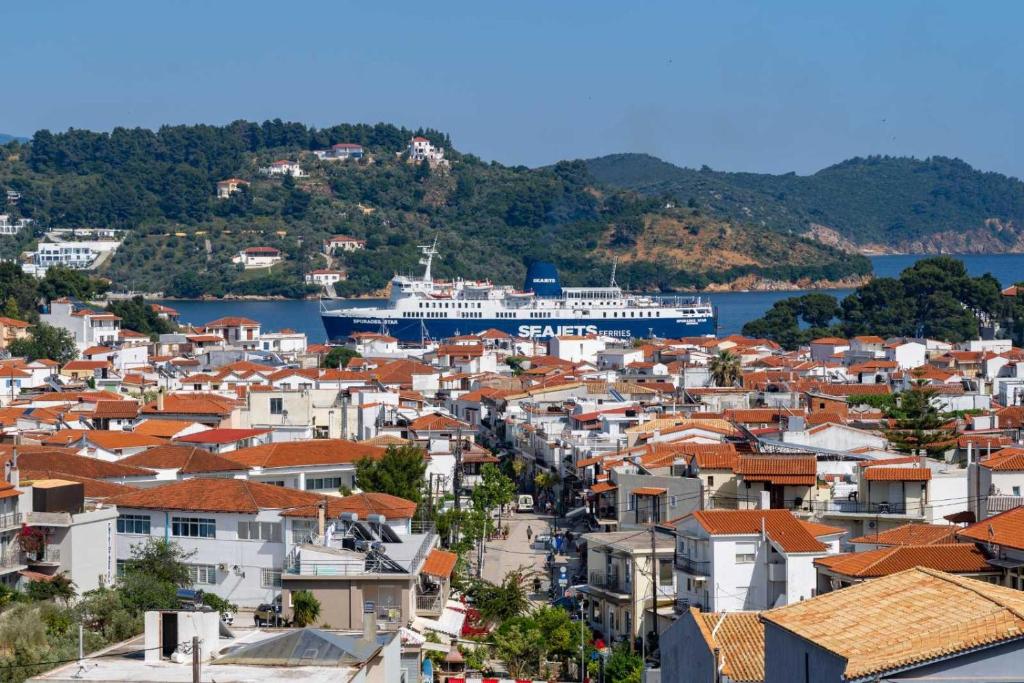 a view of a city with a cruise ship in the water at MarGio Skiathos Apartments in Skiathos