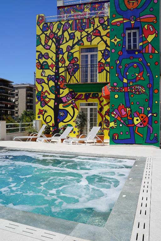 a swimming pool with a statue of a man in it at Hotel Artmadams in Palma de Mallorca