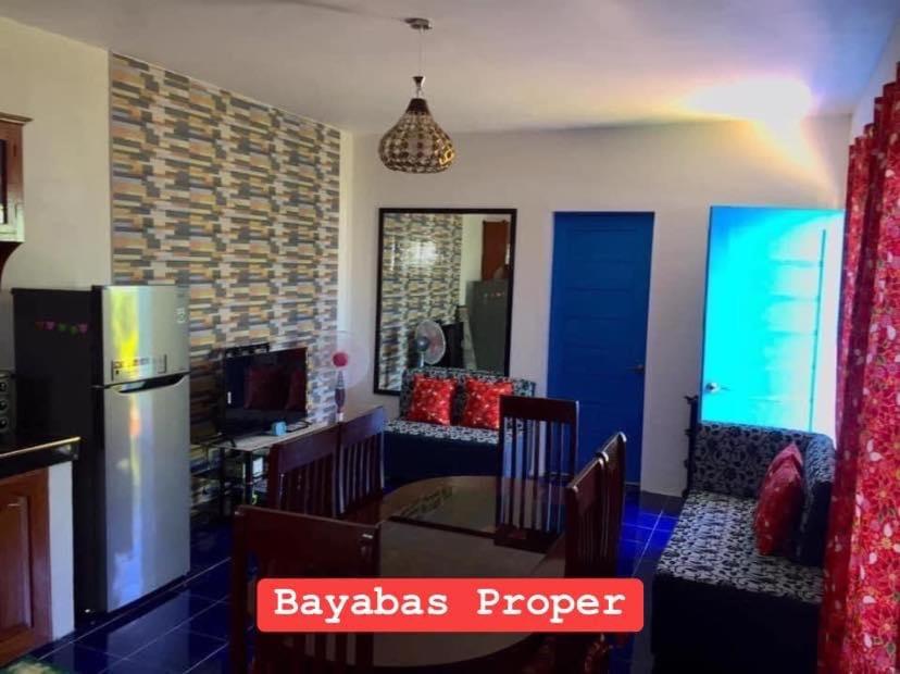 a kitchen with a table and chairs in a room at Bayabas,DigFamilyApartment Fully Furnished Near Tandag City in Somosomo