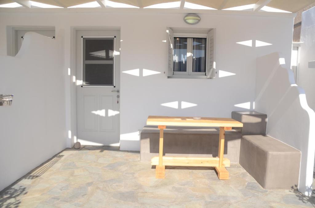 a room with a wooden table and a door at Agia Kyriaki Studios in Agia Kiriaki Beach