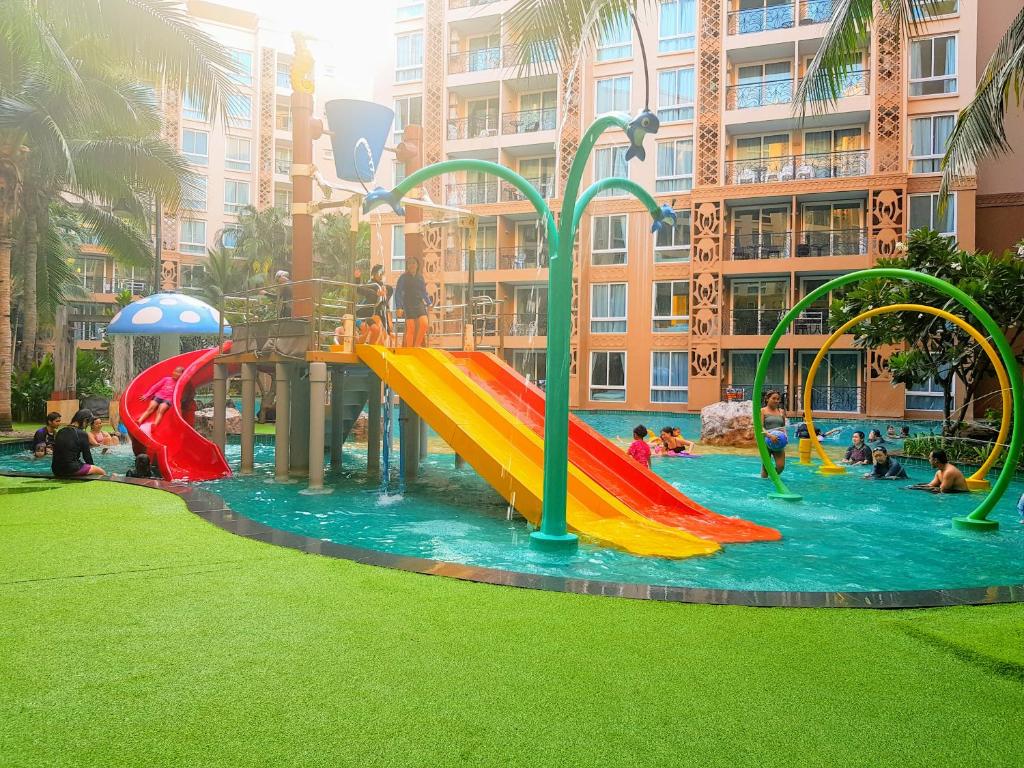 a group of people playing in a water park at Atlantis Condo Resort GP in Jomtien Beach