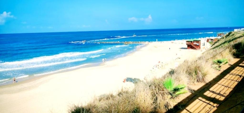 a view of a beach with the ocean at Short Term Apartment Tel Aviv Bat Yam 411 in Bat Yam