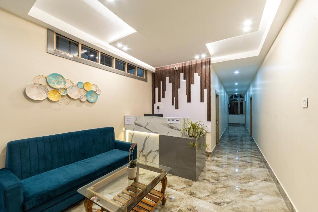 a living room with a blue couch and a table at Citrus Boutique Hotel in Gangtok