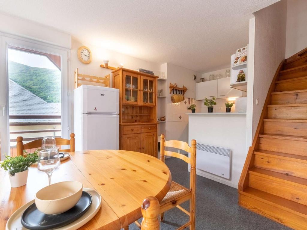 a kitchen and dining room with a wooden table at Appartement Saint-Lary-Soulan, 5 pièces, 8 personnes - FR-1-296-306 in Saint-Lary-Soulan