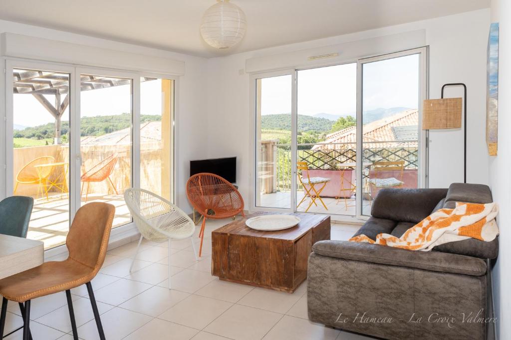 a living room with a couch and a table at Le Hameau in La Croix-Valmer