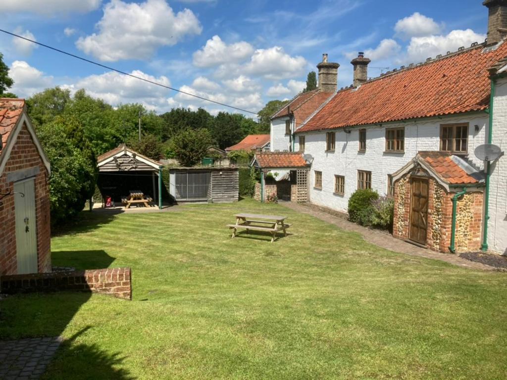 a yard with a picnic table and buildings at Wensum House in Norwich
