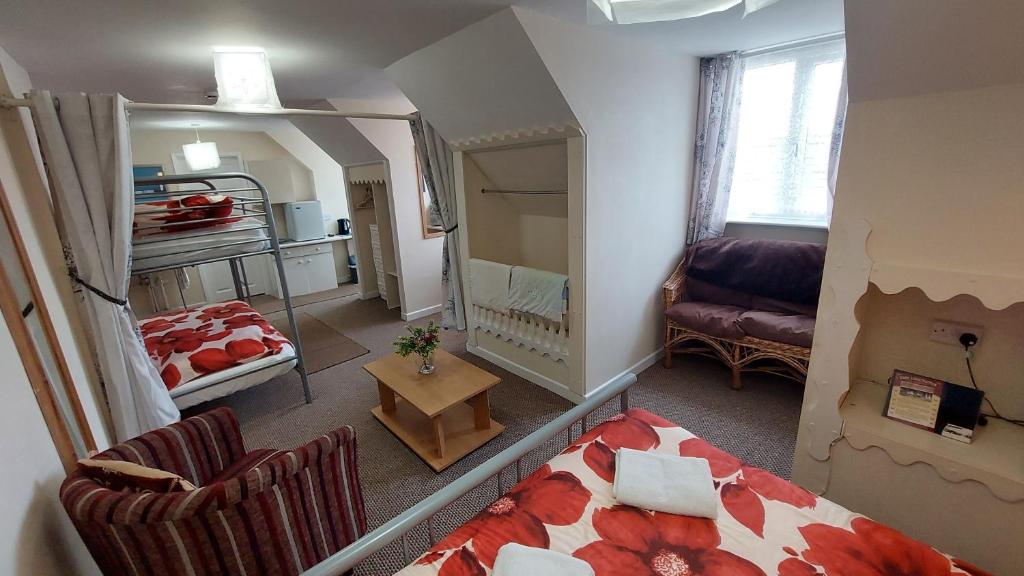 a small living room with a bed and a couch at Tennyson Lodge in Mablethorpe