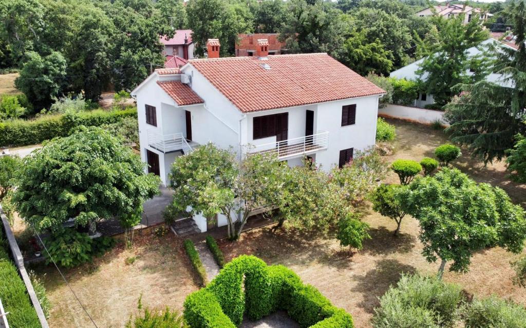 an aerial view of a white house with trees and bushes at Valica Gardens in Savudrija