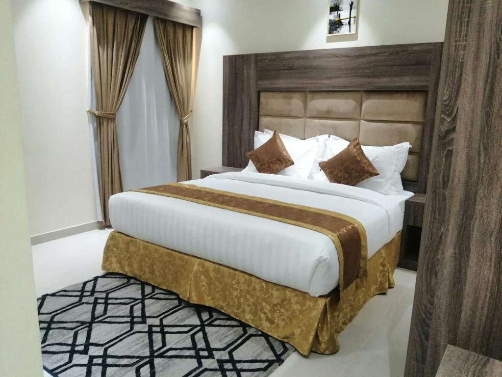 מיטה או מיטות בחדר ב-منازل الطيف للوحدات السكنية