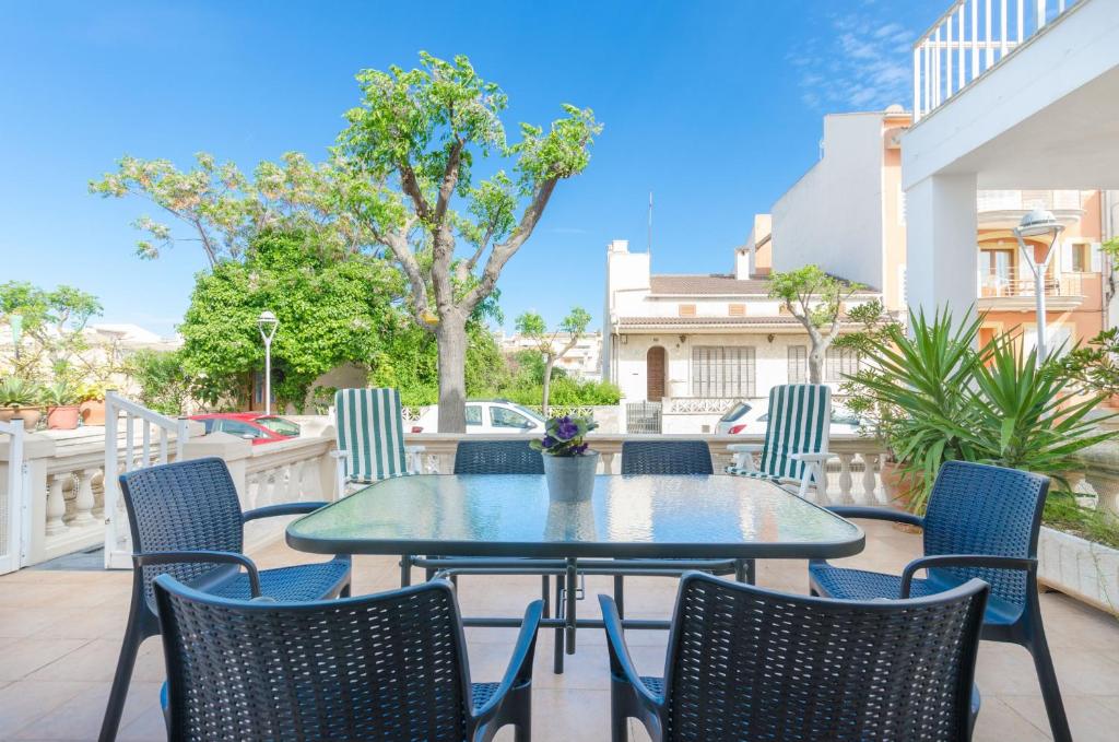 a patio with a table and chairs on a balcony at YourHouse Casa Rafael in Can Picafort