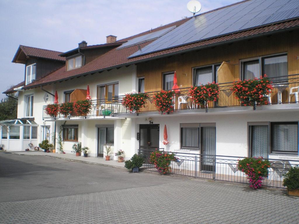 ein Gebäude mit Blumen auf den Balkonen in der Unterkunft Voglöder Hof in Bad Füssing