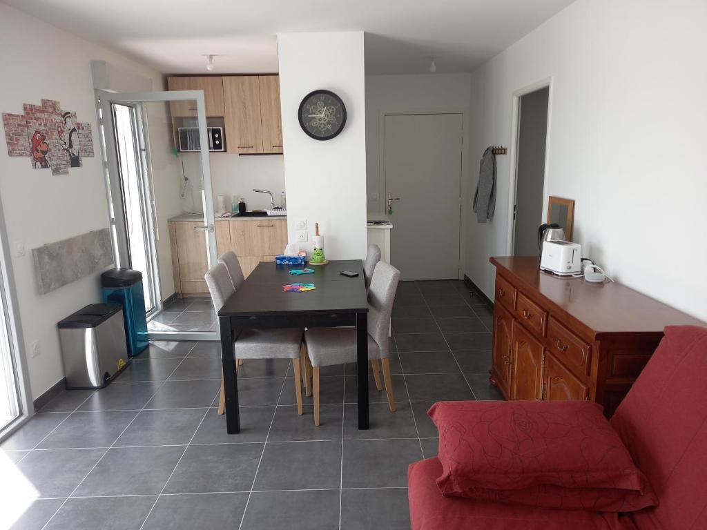 un salon avec une table de salle à manger et une cuisine dans l'établissement Appartement résidence récente, à Bayonne