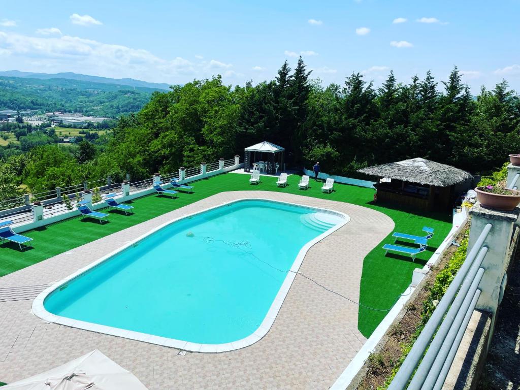 a swimming pool in a yard with lounge chairs at Villa Ester in Tagliolo Monferrato