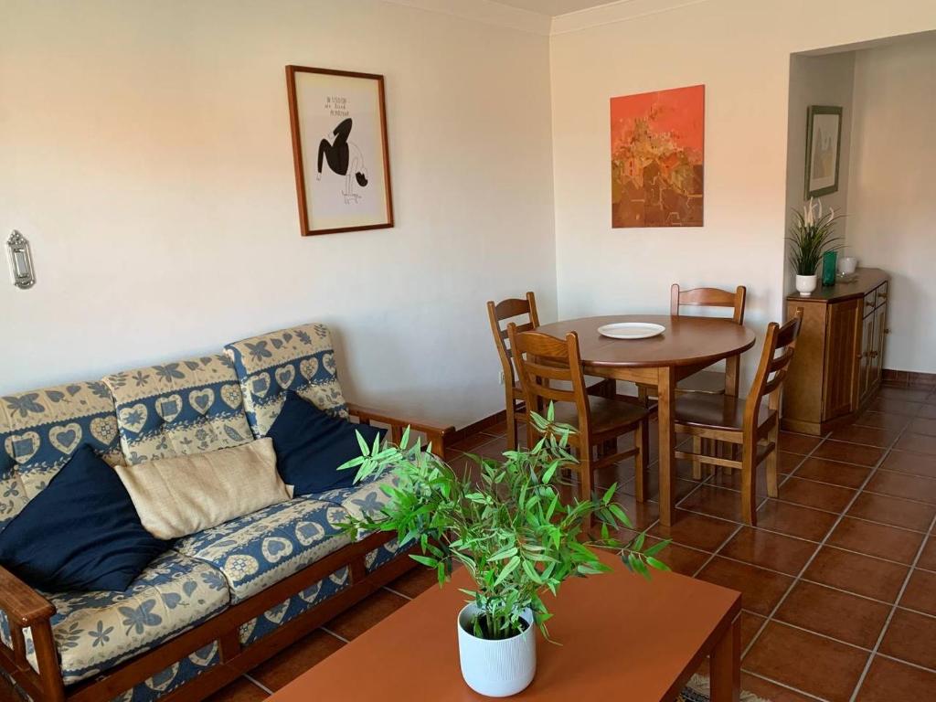 a living room with a couch and a table at Sesimbra Concept in Sesimbra
