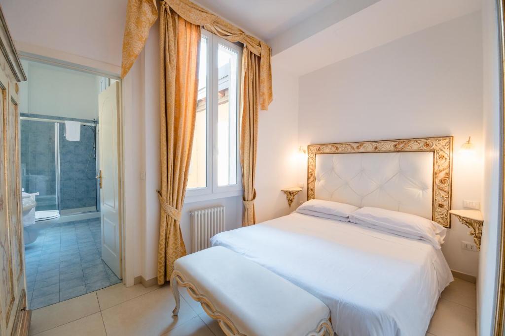 a hotel room with a large bed and a large window at Residenza Due Torri check in presso HOTEL CENTRALE Vicolo Cattani 7 in Bologna