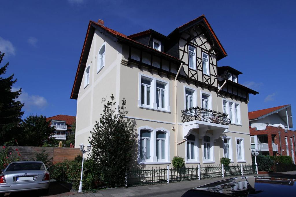 a white house with a black roof at Hotel Galerie in Seelze