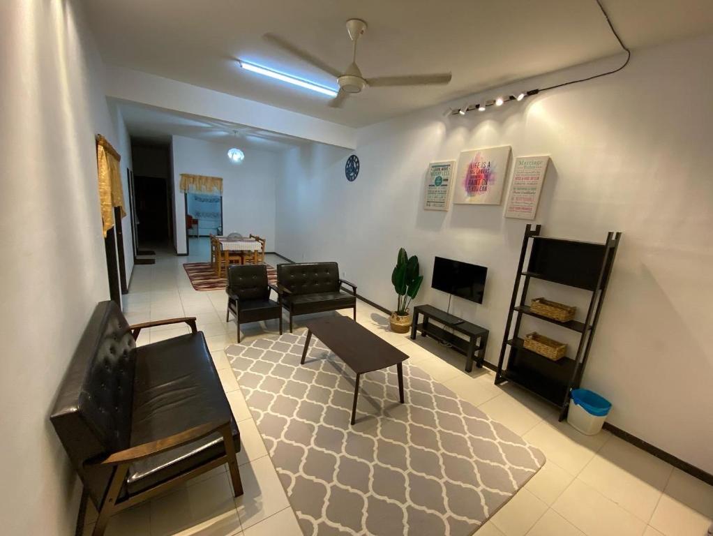 a living room with a couch and a table at Medina Homestay Chukai Kemaman in Cukai
