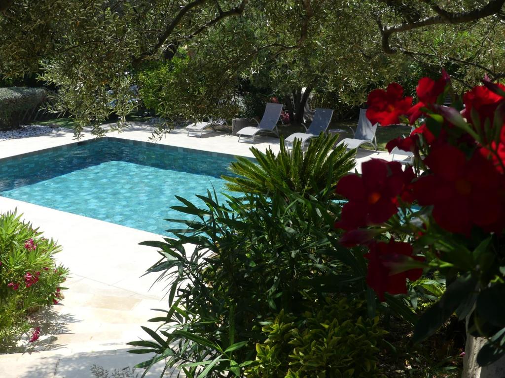 een zwembad in een tuin met bloemen bij La Calanque du Boucharel in Saint-Aygulf