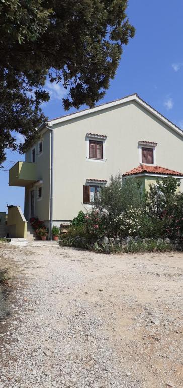 a large white building with two windows on it at Kelk Loznati in Loznati