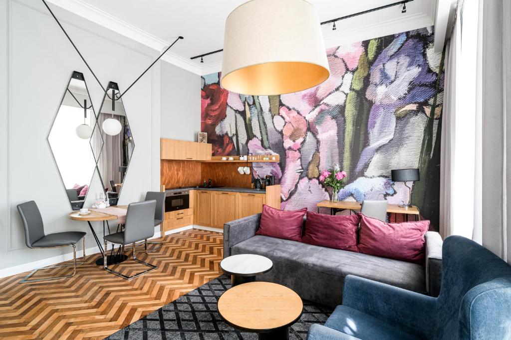 a living room with a couch and a mural at Arts Apartments City Center in Krakow