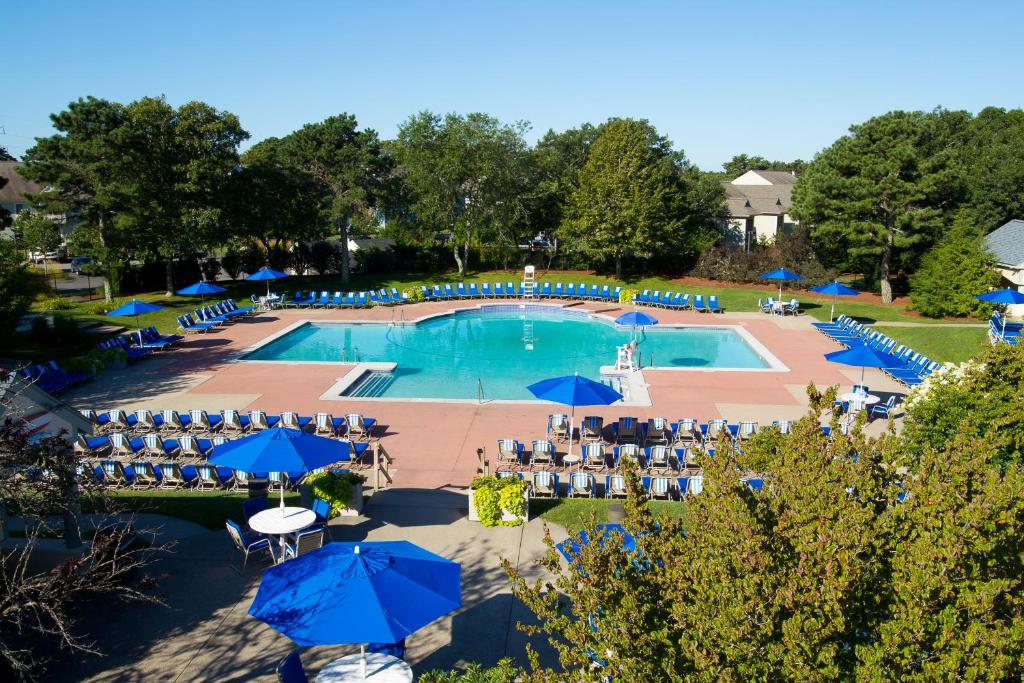 an overhead view of a pool with chairs and umbrellas at The Villages at Ocean Edge Resort & Golf Club in Brewster