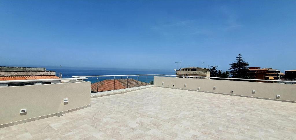 a large patio with a view of the ocean at Solmaris Tropea Rooms & Suites in Tropea